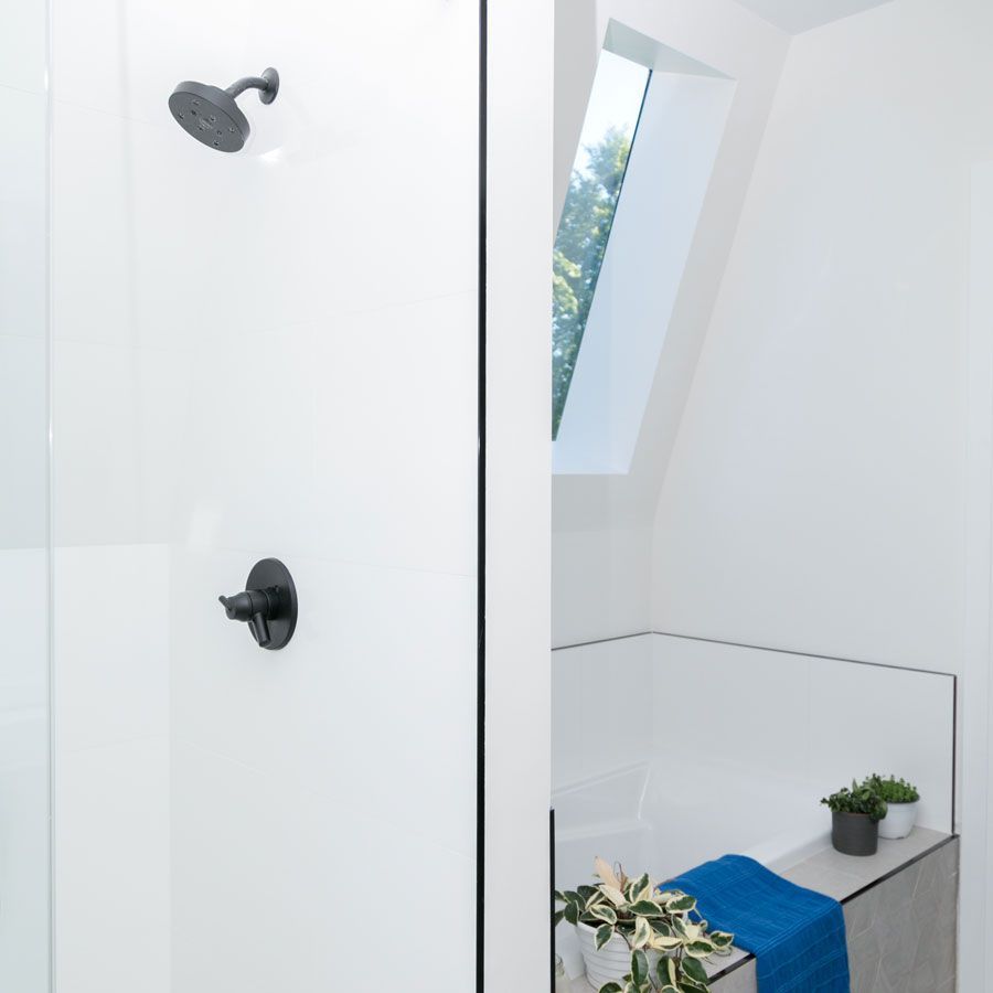 A bathroom with a shower and a window