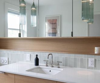 A bathroom with a sink , mirror and a picture on the wall.