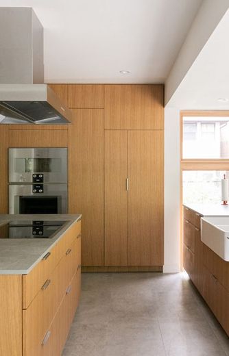 A kitchen with wooden cabinets and stainless steel appliances