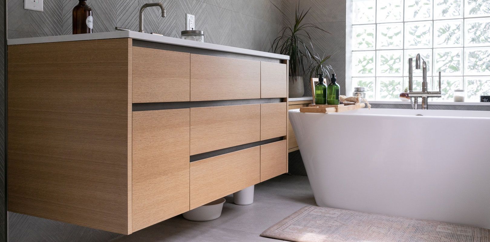 A bathroom with a bathtub , sink , and vanity.