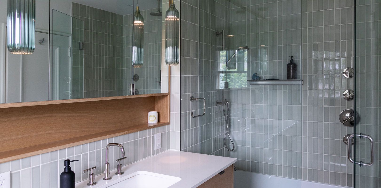 A bathroom with a sink , shower , tub and mirror.