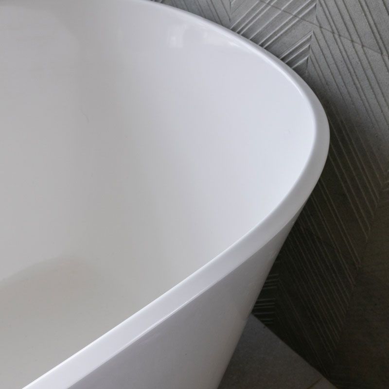 A close up of a white bathtub in a bathroom.