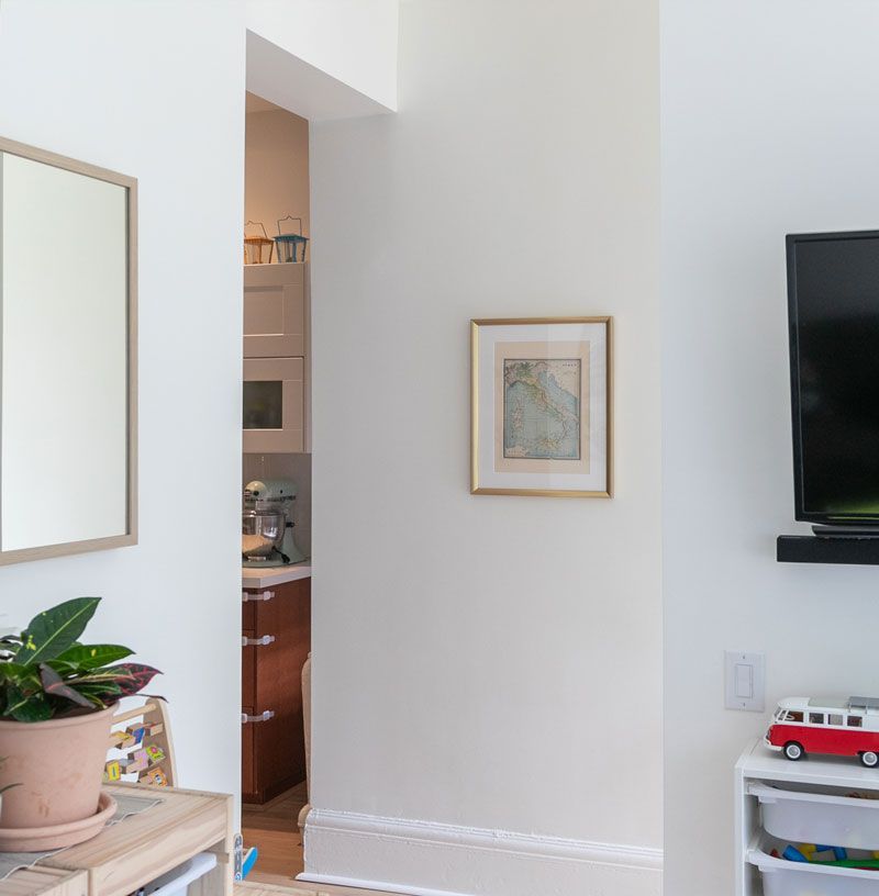 A living room with a tv and a picture on the wall