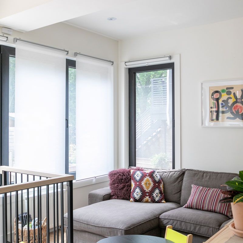 A living room with a couch and a picture on the wall