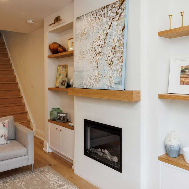 A living room with a fireplace and stairs