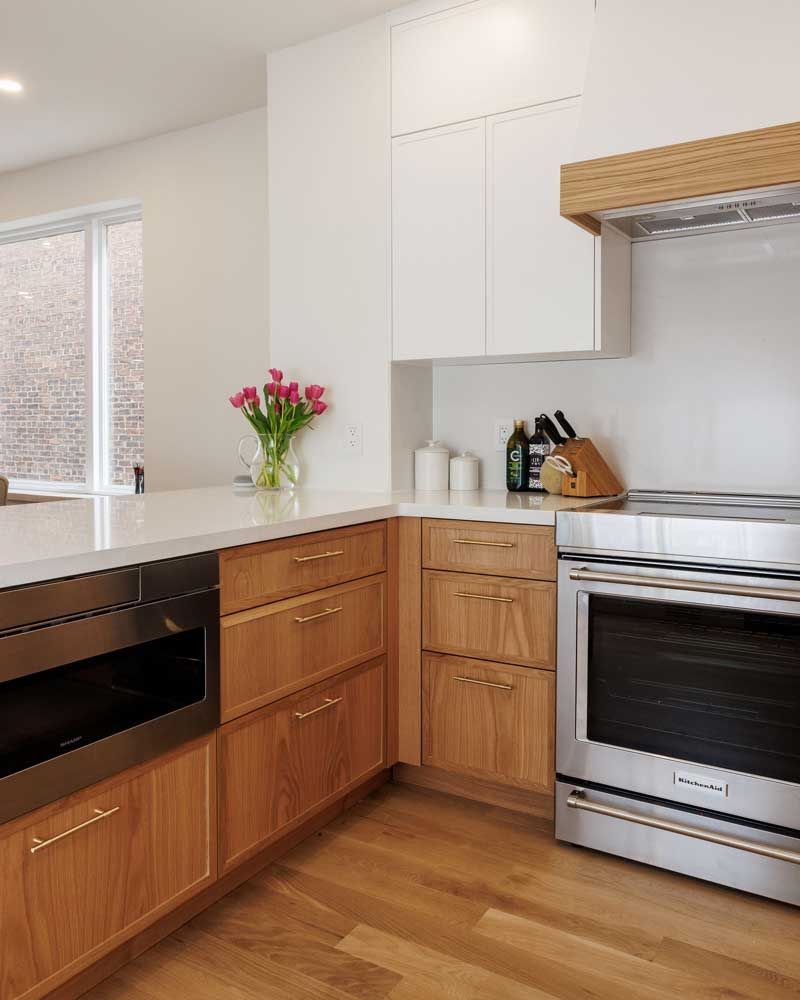 A kitchen with wooden cabinets and stainless steel appliances.