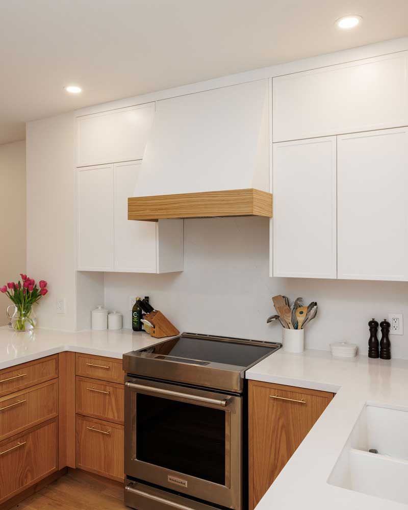 A kitchen with stainless steel appliances and wooden cabinets