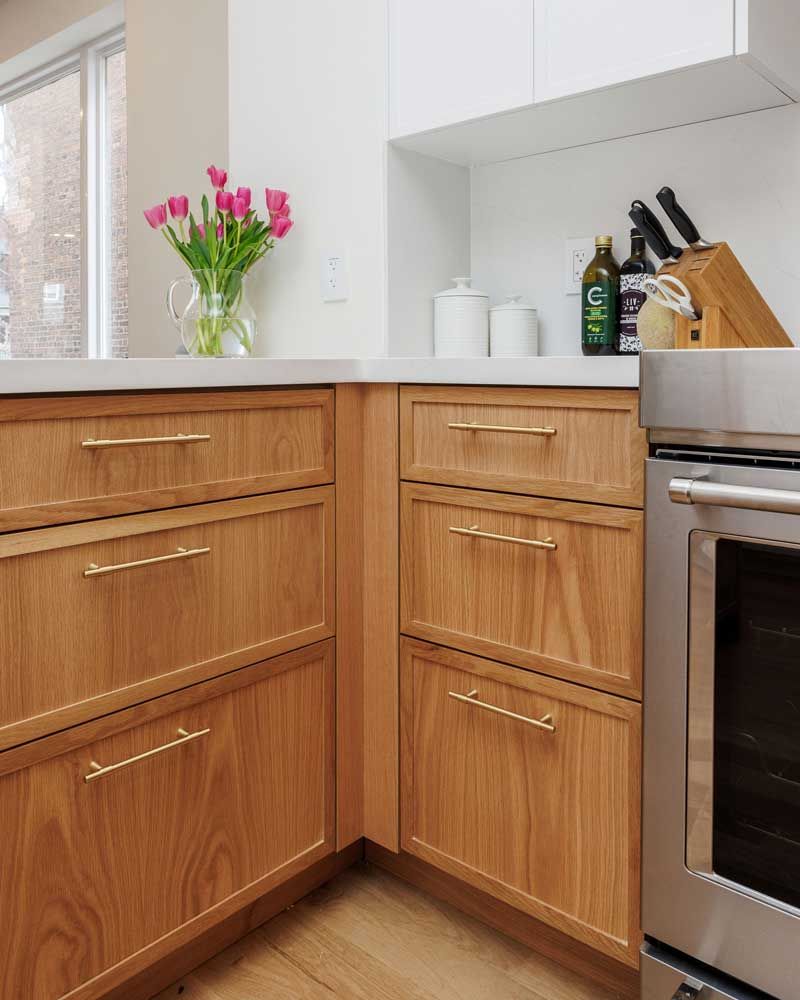 A kitchen with wooden cabinets and a stainless steel stove