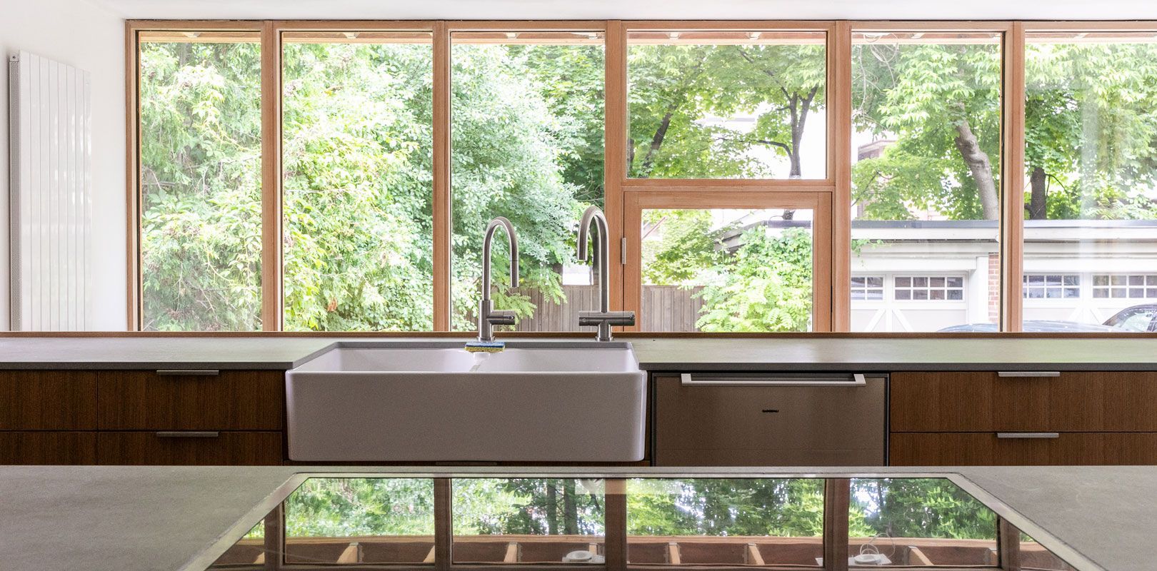 A kitchen with a sink and a lot of windows