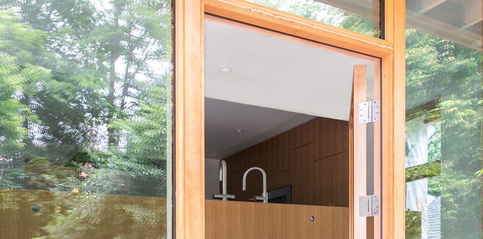 A large window with a wooden frame is open to a kitchen.