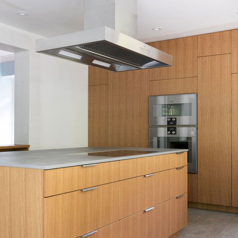 A kitchen with stainless steel appliances and wooden cabinets