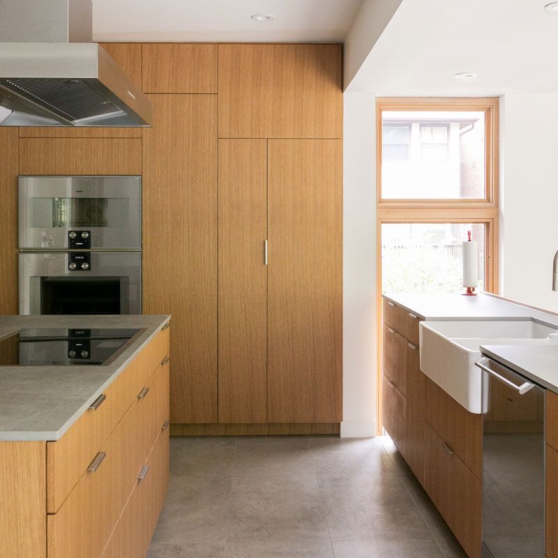 A kitchen with wooden cabinets and stainless steel appliances