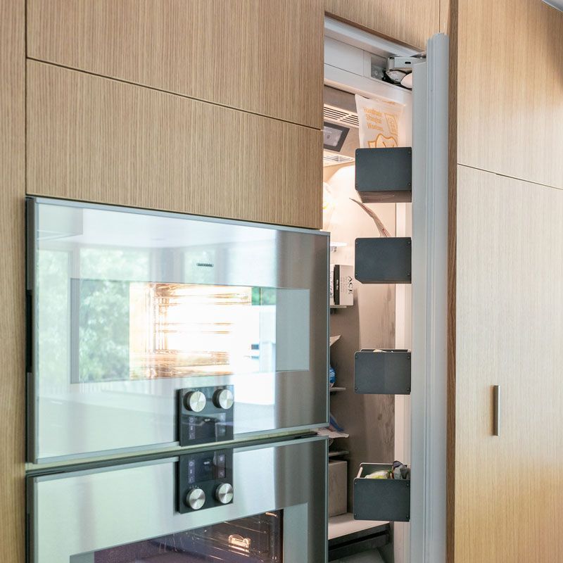 A kitchen with stainless steel appliances and wooden cabinets.