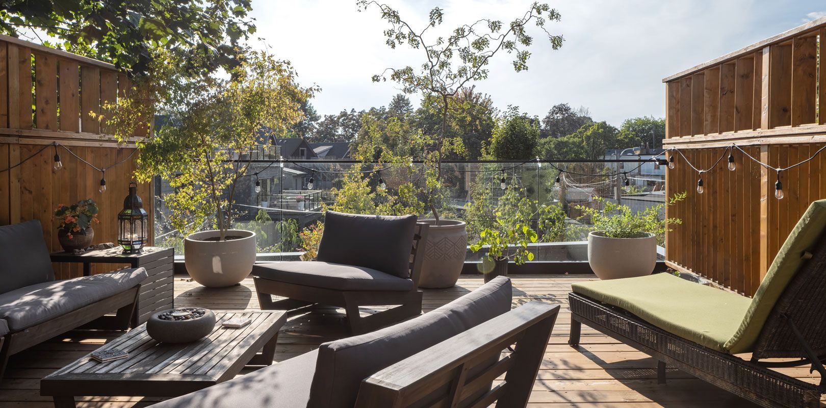 A patio with a couch , chairs , and a table.