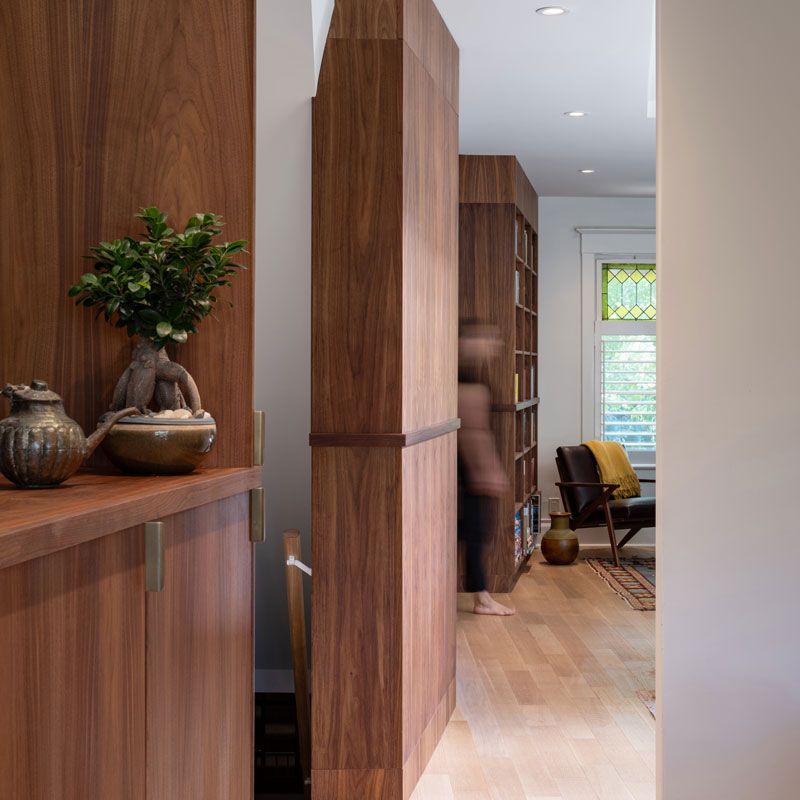 A wooden cabinet with a plant on top of it