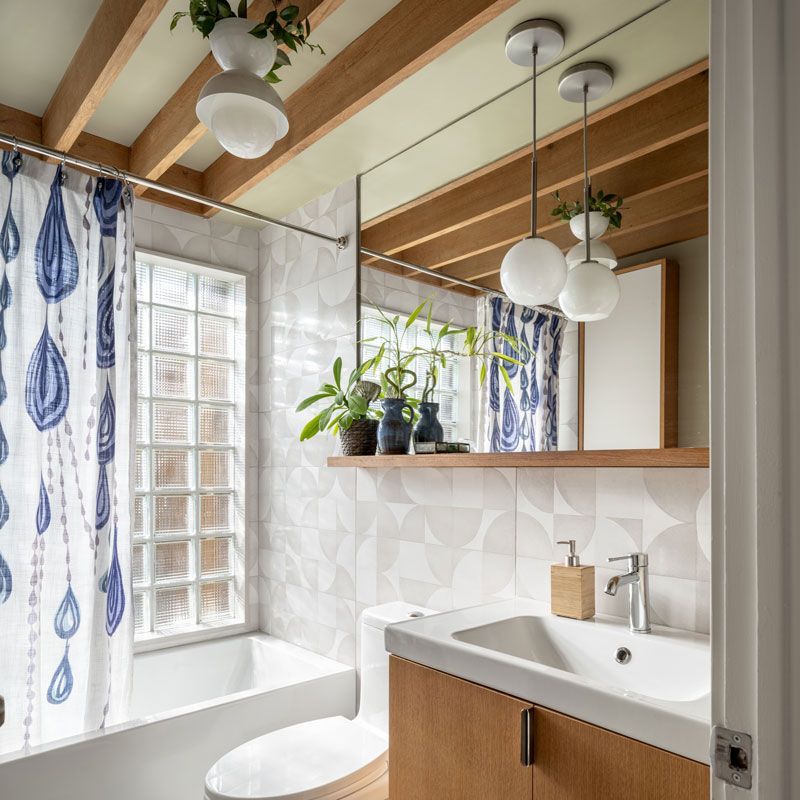 A bathroom with a toilet , sink , and mirror