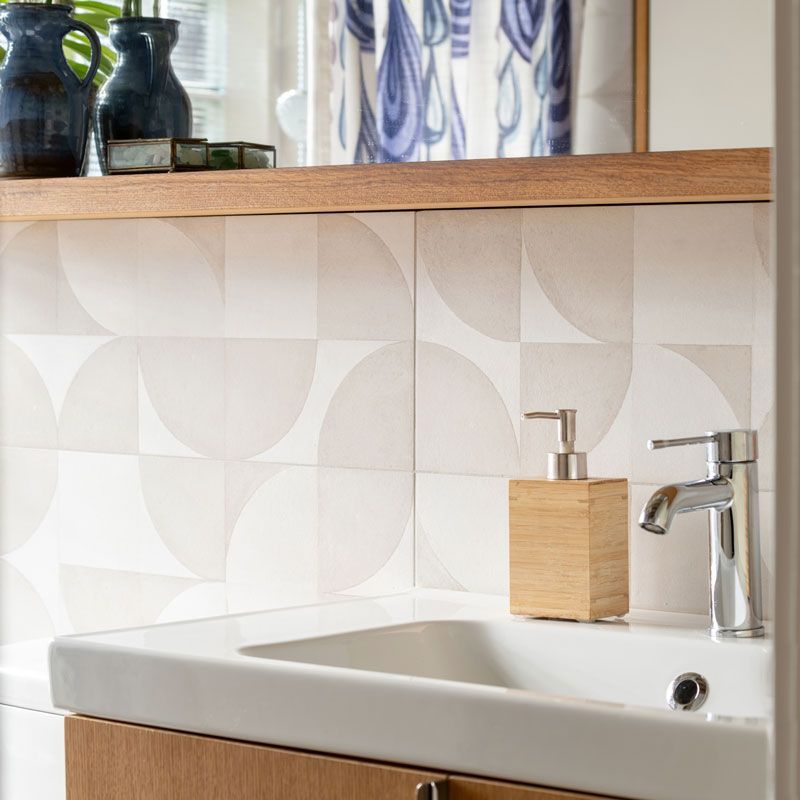 A bathroom sink with a wooden soap dispenser on it