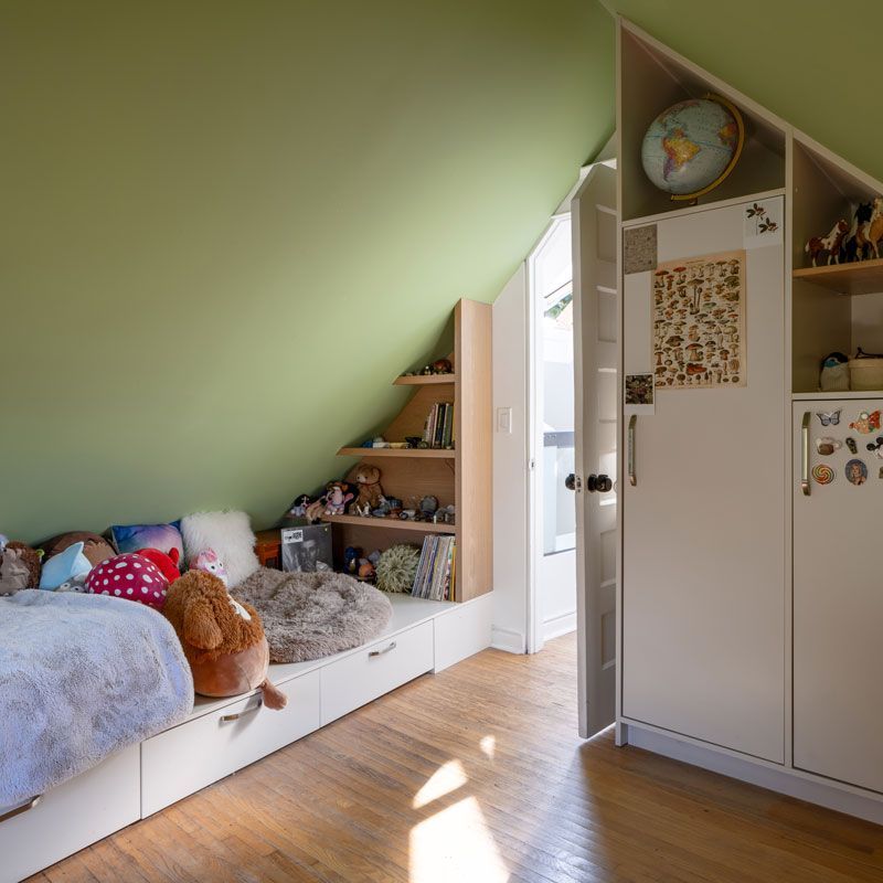 A bedroom with a bed and a globe on the wall