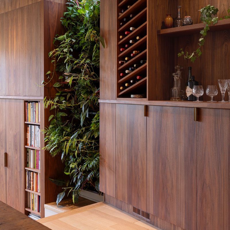 A shelf with wine bottles and glasses on it
