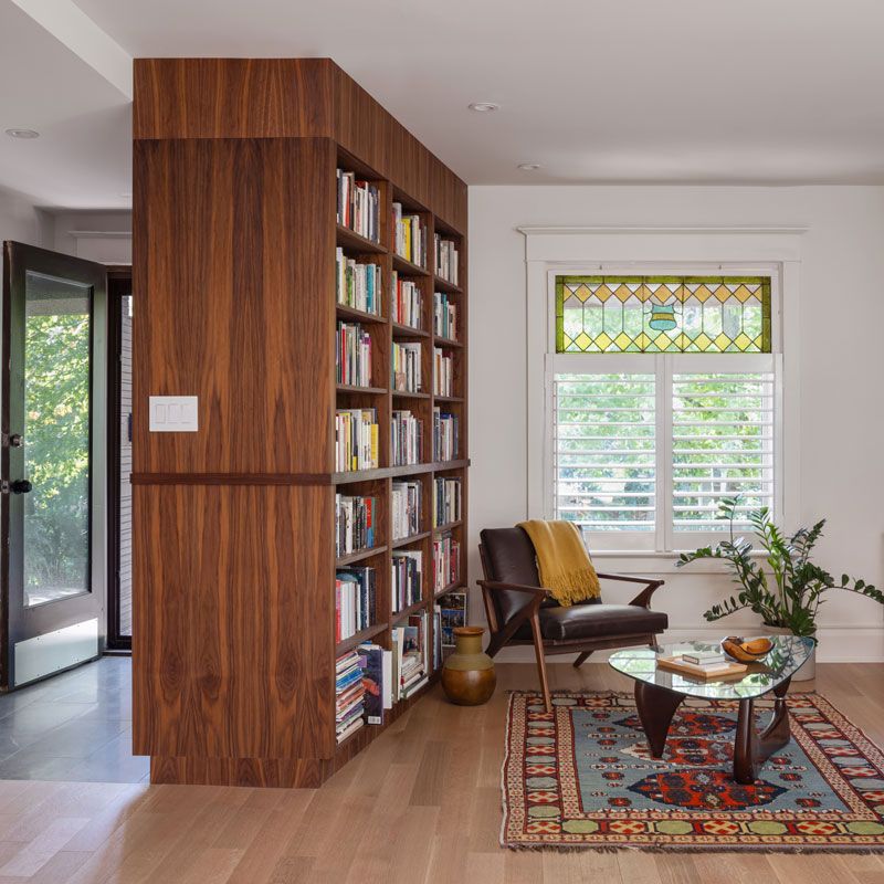 A living room with a bookshelf and a chair