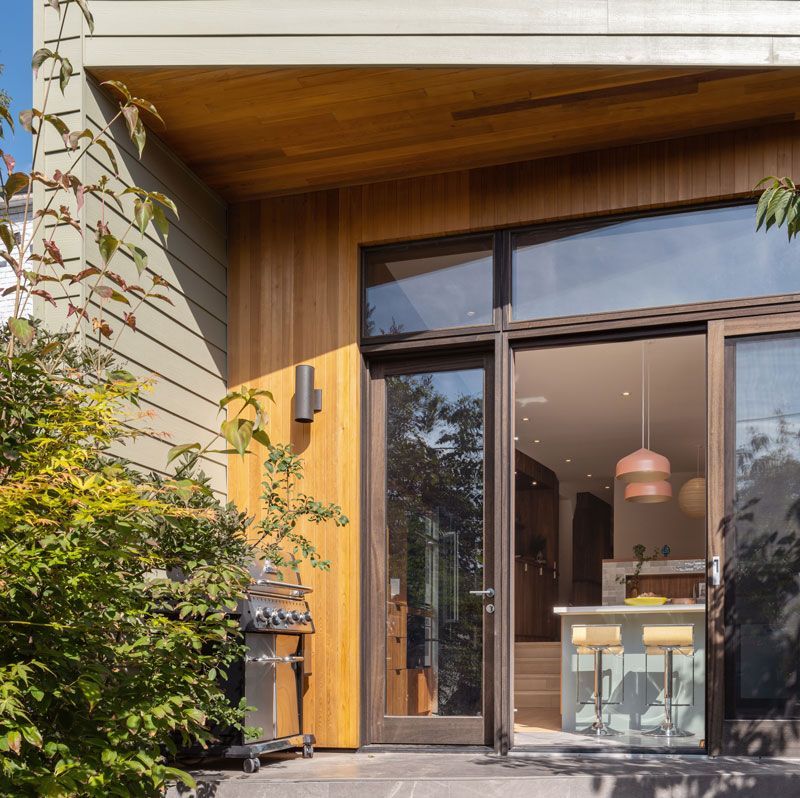 A house with a sliding glass door and a grill