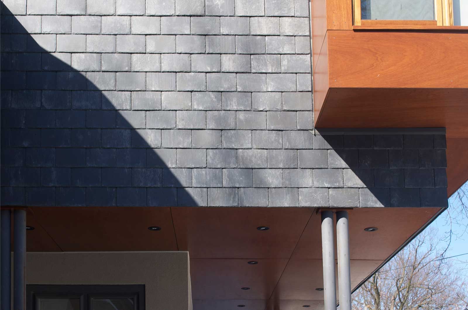 A building with a roof made of slate and wood