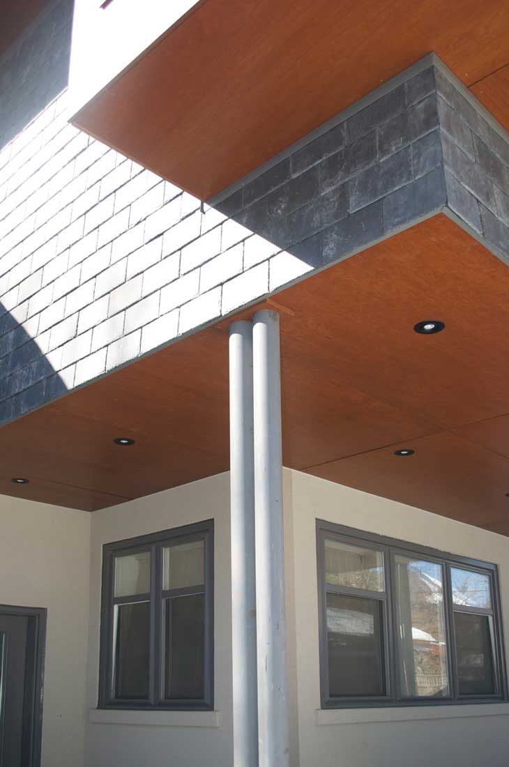 A white building with a wooden ceiling and windows