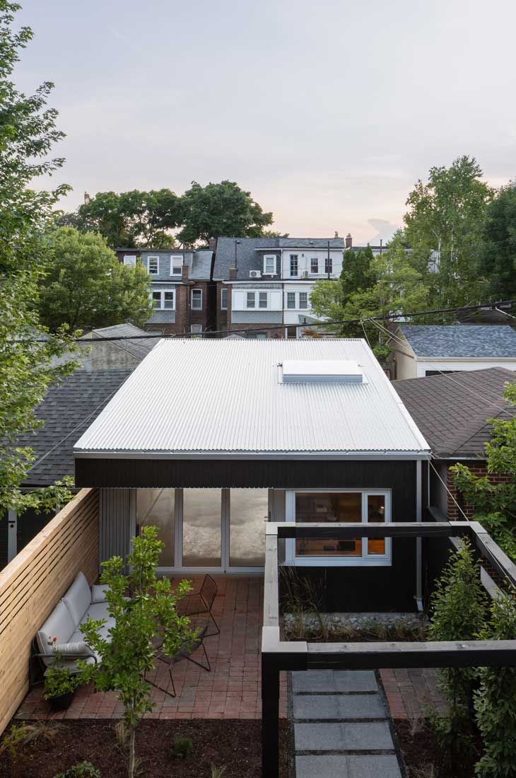 An aerial view of a house with a white roof