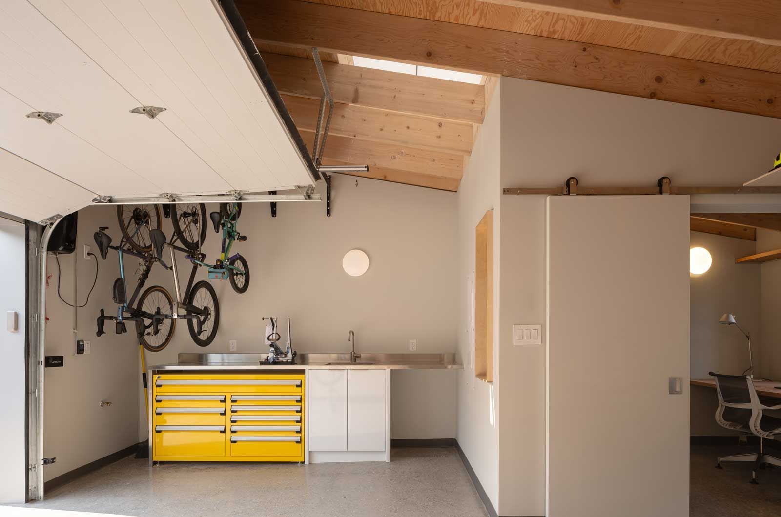 A large window with a wooden frame is open to a kitchen.