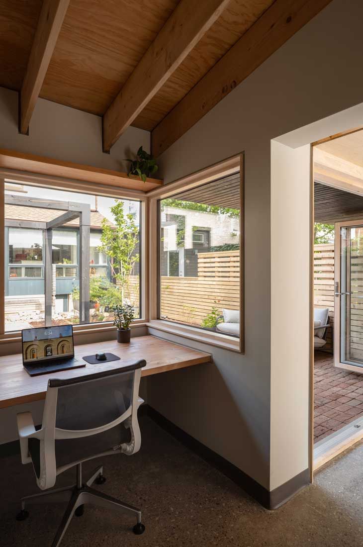 A black and white striped teepee sits in front of a window