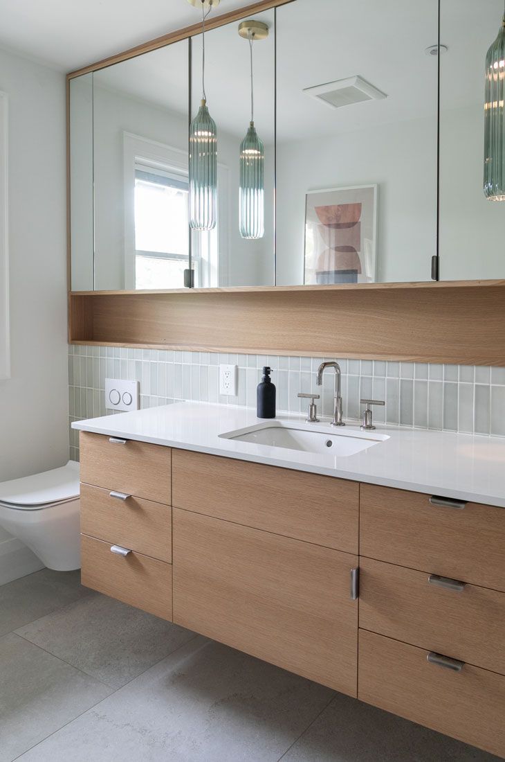 A bathroom remodel with a sink, toilet, and mirror
