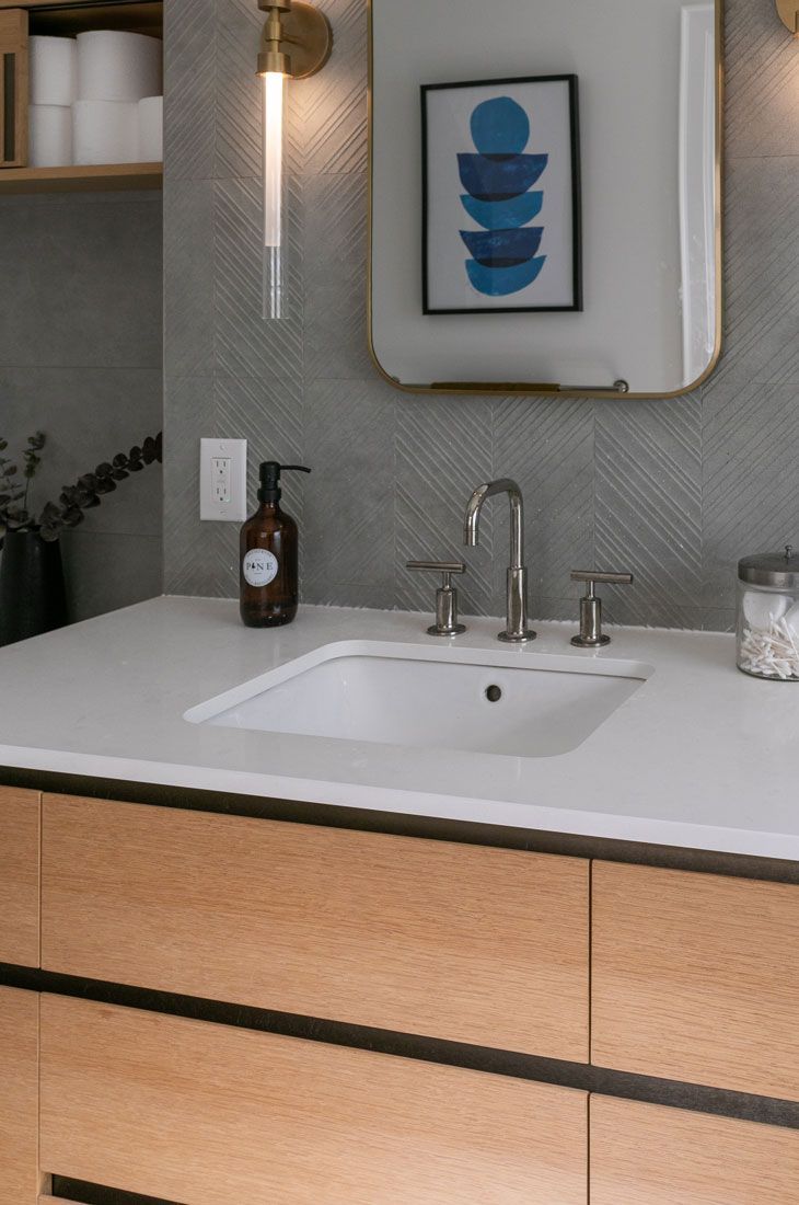 A bathroom remodel with a sink and a picture on the wall