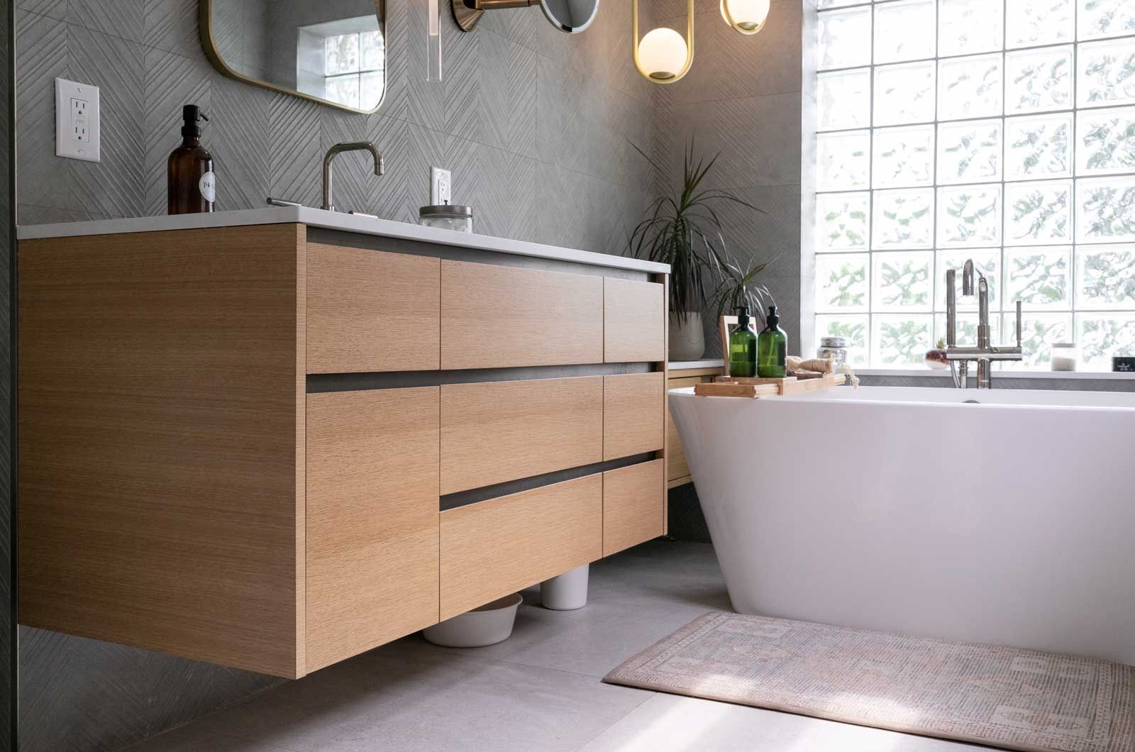 A bathroom with a bathtub, sink, and mirror.