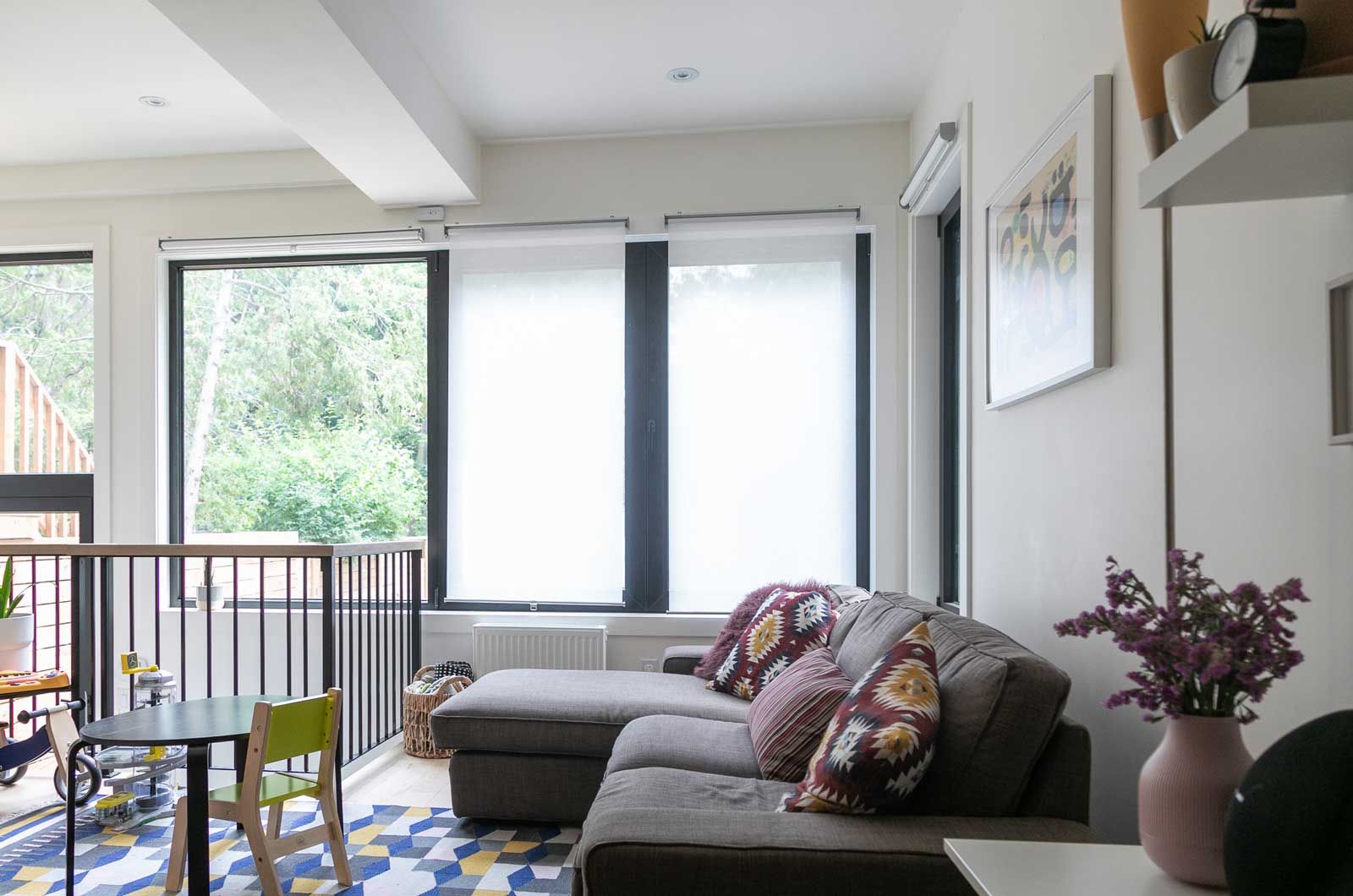 A living room with a couch , table and chairs