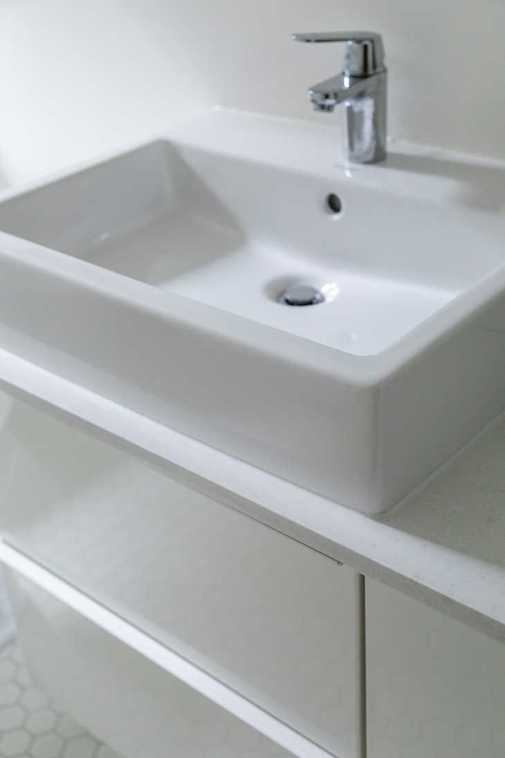A bathroom sink with a faucet on top of it
