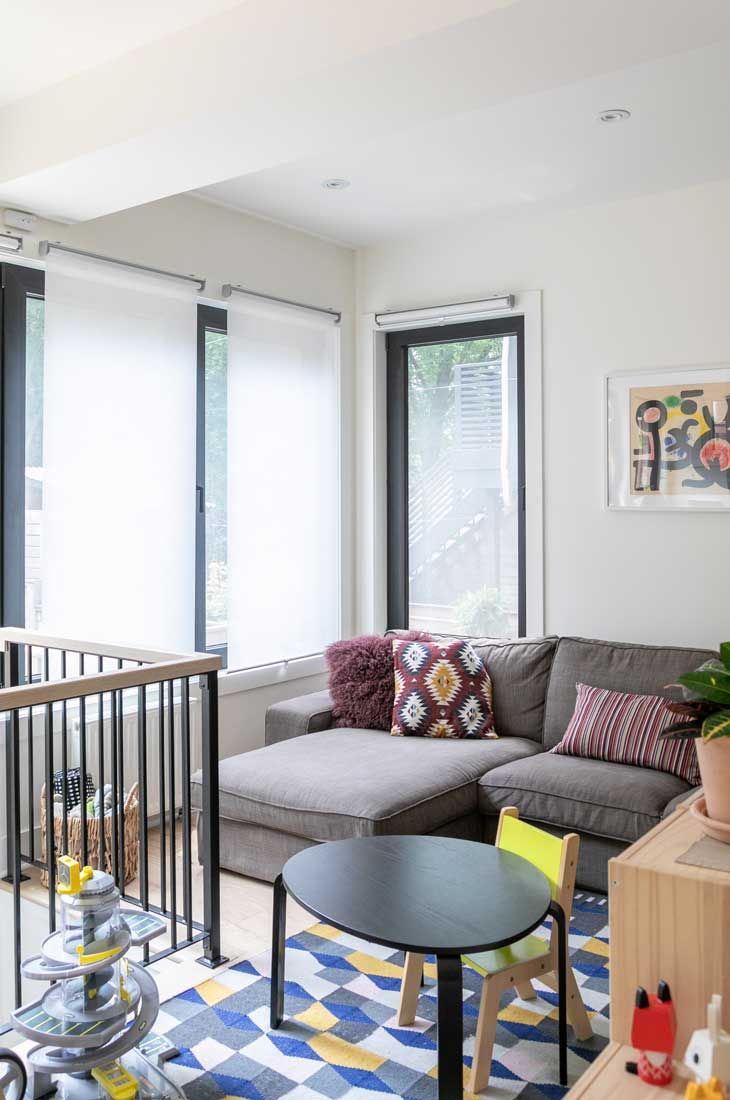 A living room with a couch , table and chairs.