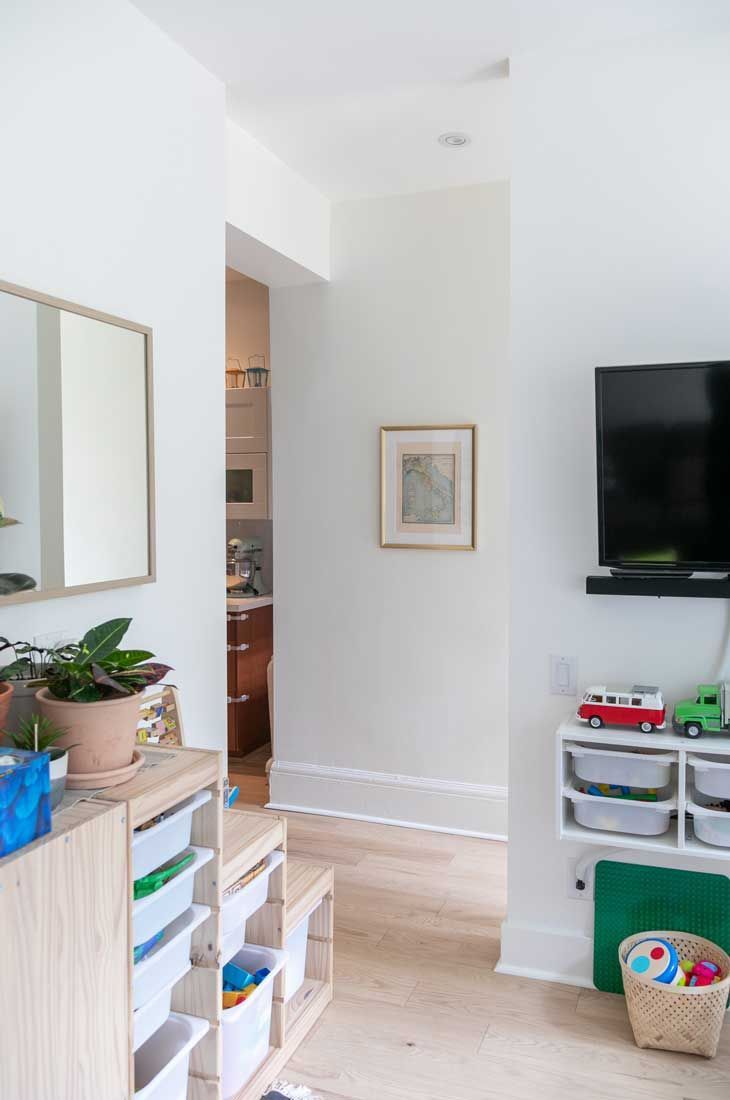 A living room filled with lots of toys and a flat screen tv.
