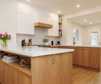 A kitchen with wooden cabinets and a white counter top