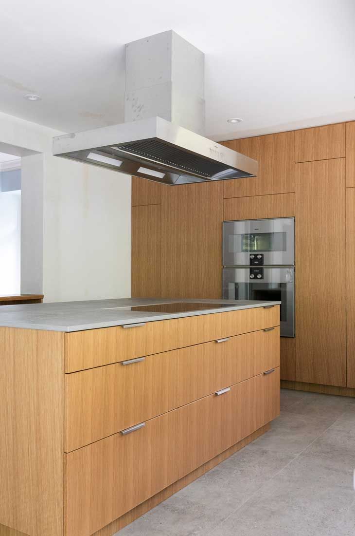 A kitchen with wooden cabinets and stainless steel appliances