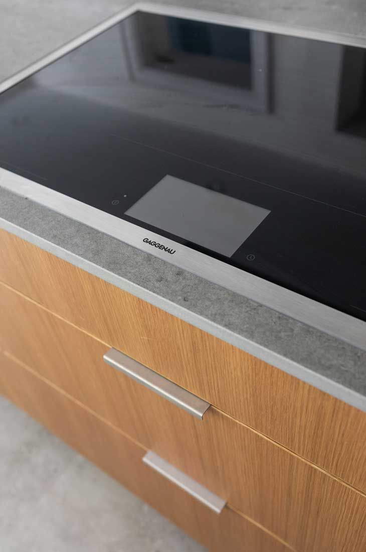 A stove top oven is sitting on top of a wooden cabinet.