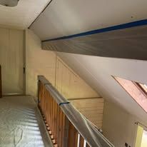 A hallway with stairs leading up to the second floor of a house.