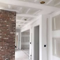 There is a brick wall in the middle of the hallway.