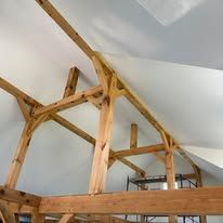 A room with wooden beams and a white ceiling.