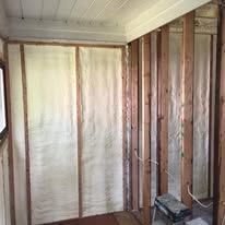A room with foam insulation on the walls and ceiling.