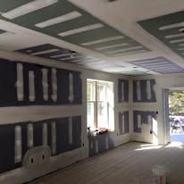 A room with a lot of drywall on the walls and ceiling.
