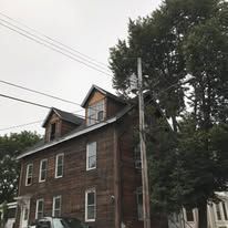 A large brick building with a car parked in front of it.
