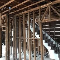 A wooden frame of a house with stairs in it.