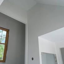 A room with a window and a ceiling in a house.