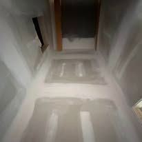 A hallway with a shadow of a person on the floor.