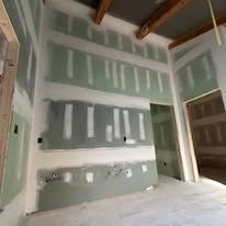 A room with a lot of drywall on the walls and ceiling.